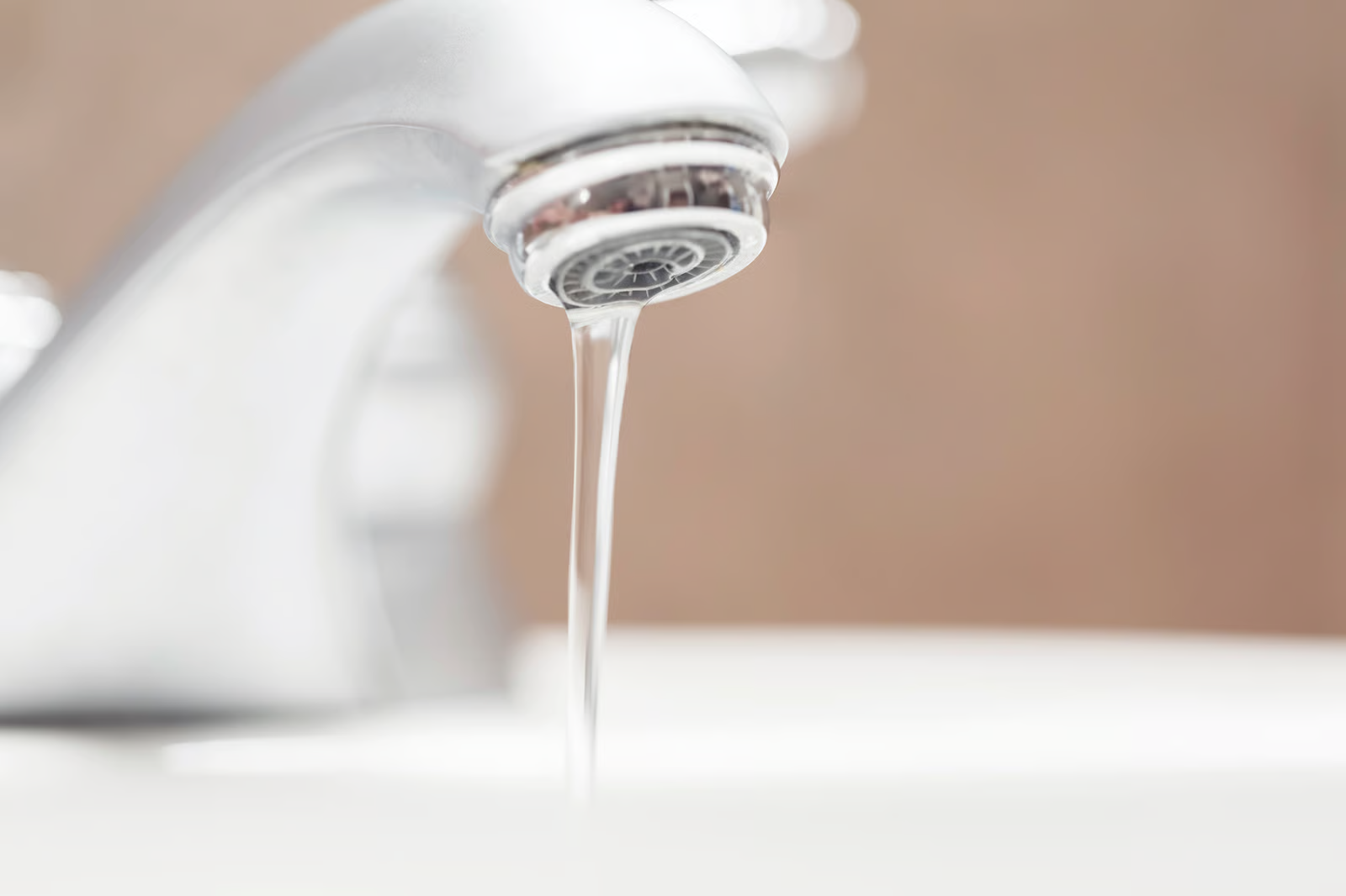 Plumbing fixture repair showing sink faucet with weak water flow.